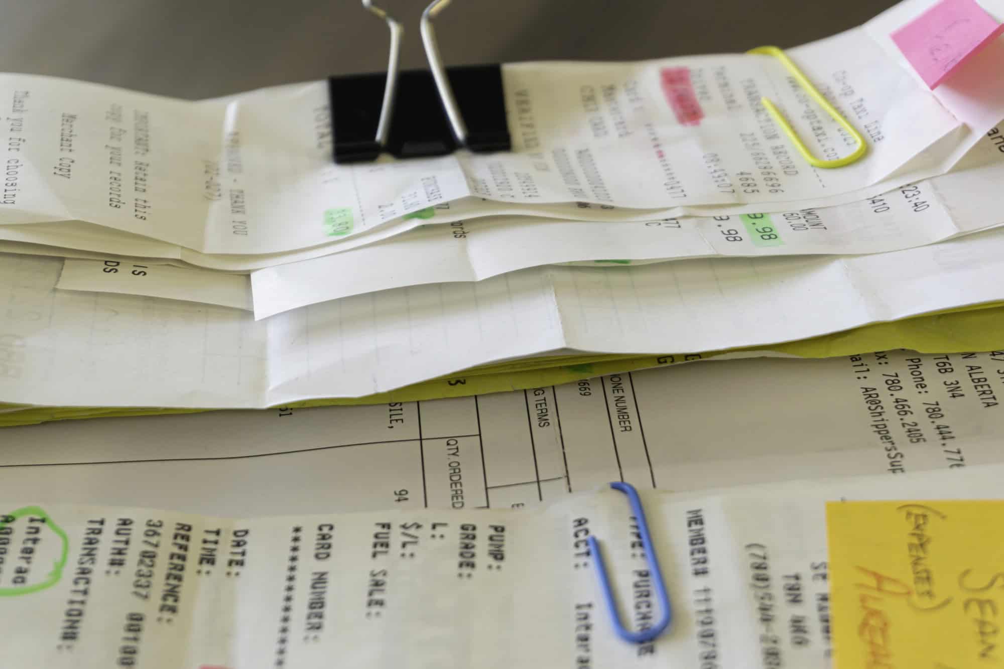 Close-up of insurance agent making calculations while signing ag Processing and receiving transactions in Spokane WA